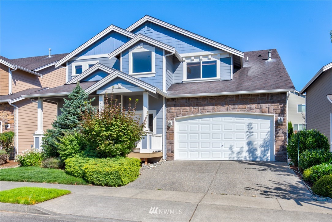 21215 40th Drive Southeast Bothell, WA 98021 - Photo 1 of 25 a front view of a house with a yard and garage