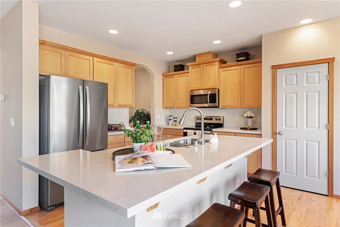 21215 40th Drive Southeast Bothell, WA 98021 - Photo 7 of 25 a kitchen with sink refrigerator and microwave