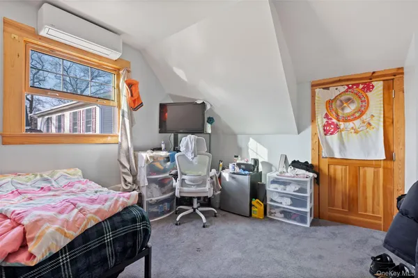a bedroom with bed and a window