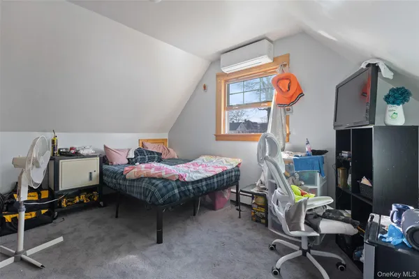 a bedroom with furniture and a window