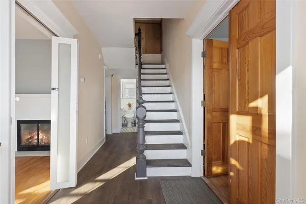 a view of a hallway with wooden floor and entryway