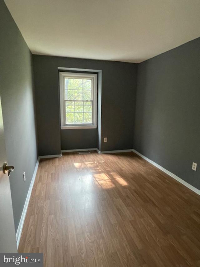 3545 Moultree Place Nottingham, MD 21236 - Photo 8 of 28 an empty room with wooden floor and windows