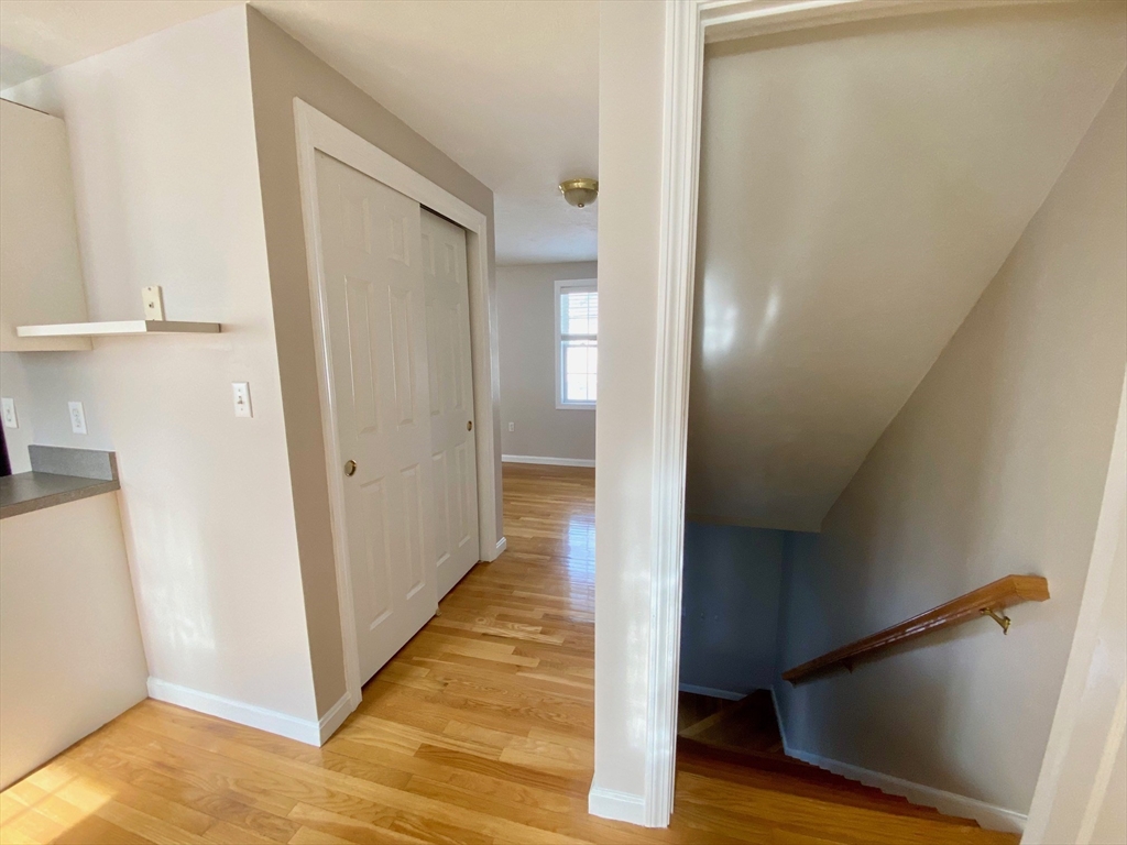 985 Trapelo Road, Unit 6 Waltham, MA 02452 - Photo 5 of 14 a view of a hallway with wooden floor