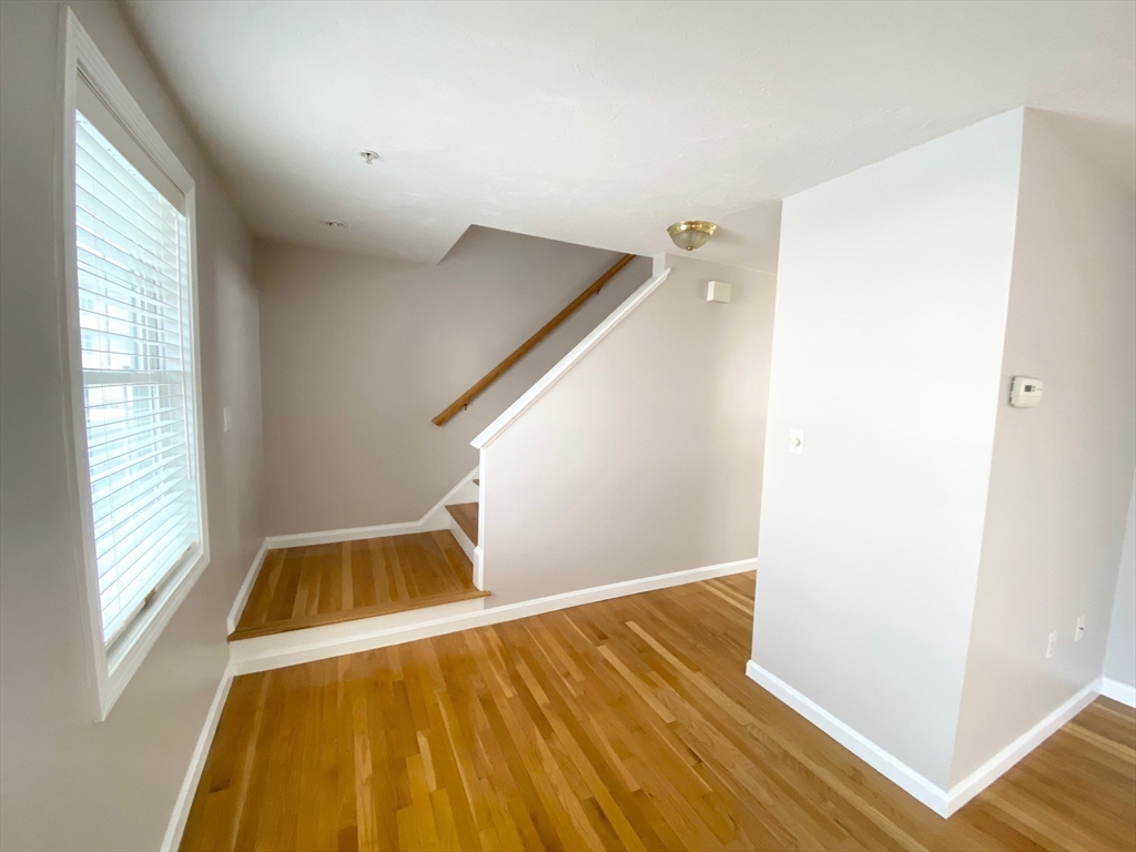 985 Trapelo Road, Unit 6 Waltham, MA 02452 - Photo 6 of 14 a view of a balcony with wooden floor and staircase