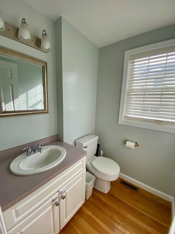 985 Trapelo Road, Unit 6 Waltham, MA 02452 - Photo 7 of 14 a bathroom with a sink a toilet and a mirror