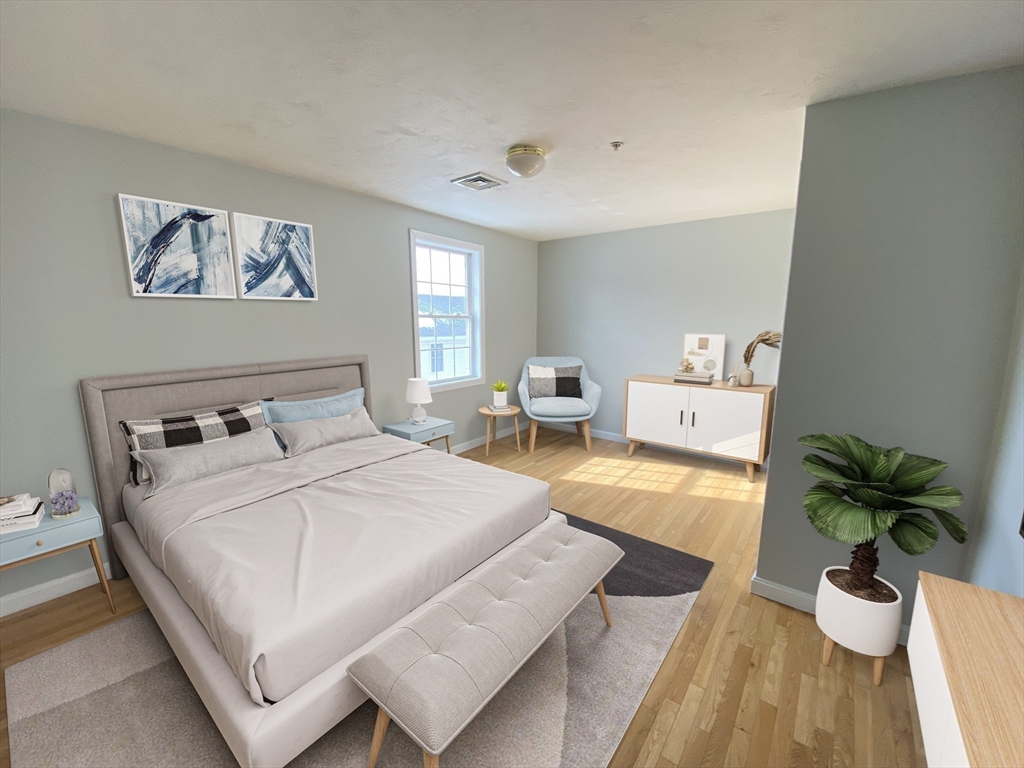 985 Trapelo Road, Unit 6 Waltham, MA 02452 - Photo 9 of 14 a bedroom with a bed and a couch