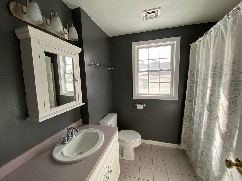 985 Trapelo Road, Unit 6 Waltham, MA 02452 - Photo 10 of 14 a bathroom with a sink toilet and mirror