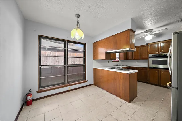 a kitchen with stainless steel appliances granite countertop a stove and cabinets