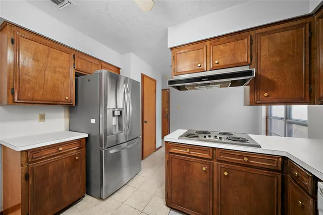 a kitchen with stainless steel appliances granite countertop a refrigerator sink and cabinets
