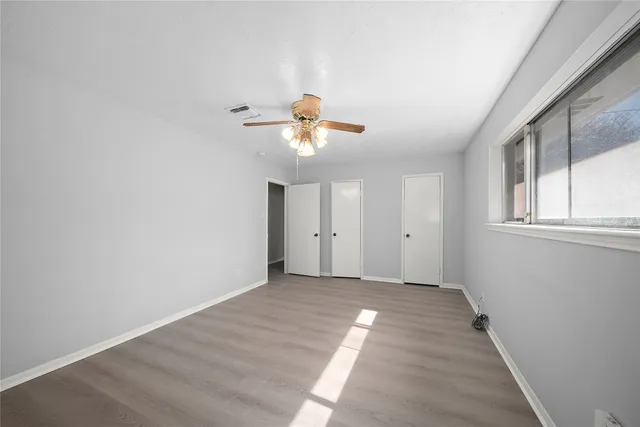 wooden floor in an empty room with a window