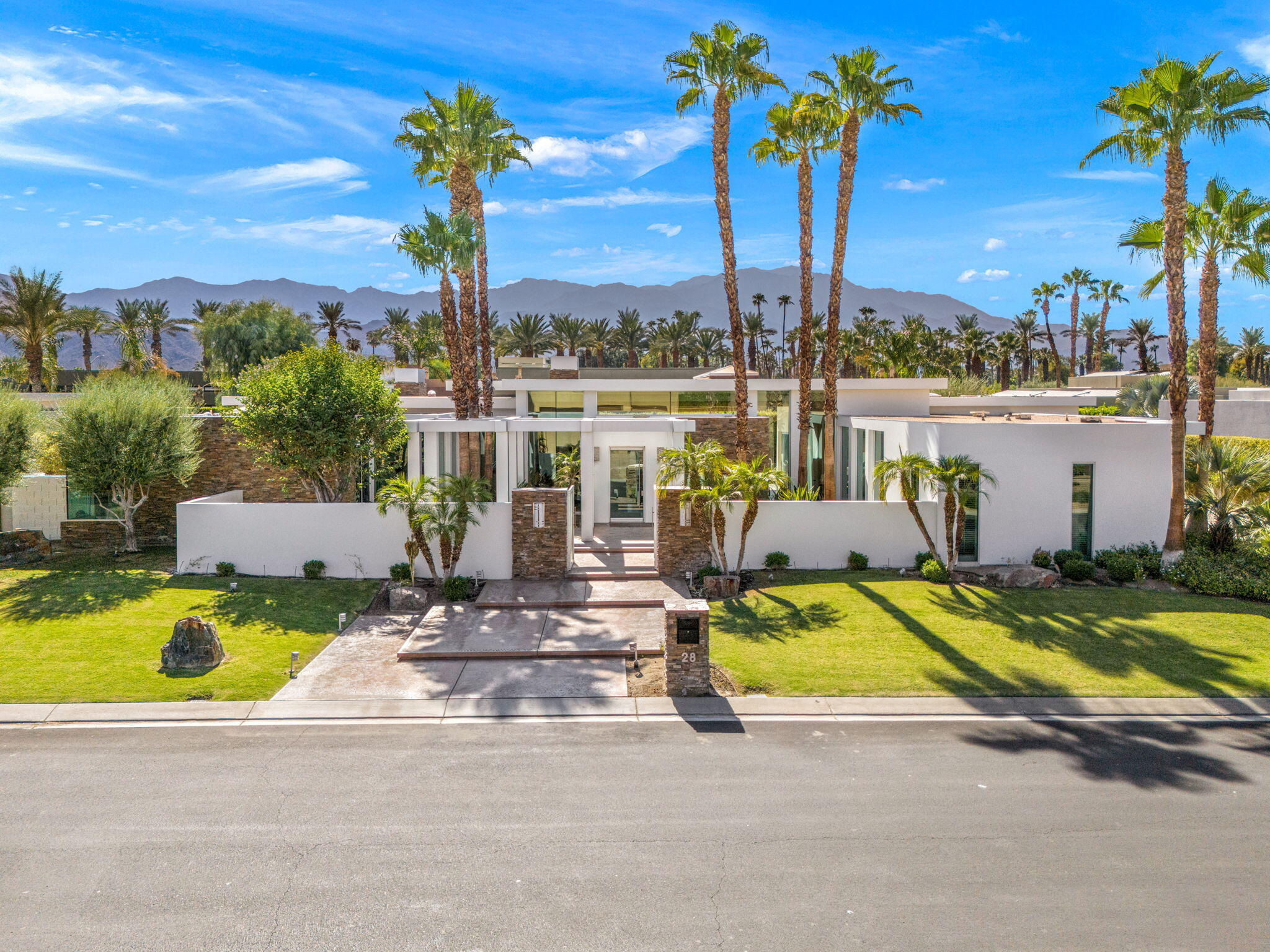 28 Sun Ridge Circle Rancho Mirage, CA 92270 - Photo 1 of 59 a view of a swimming pool with a table and chairs