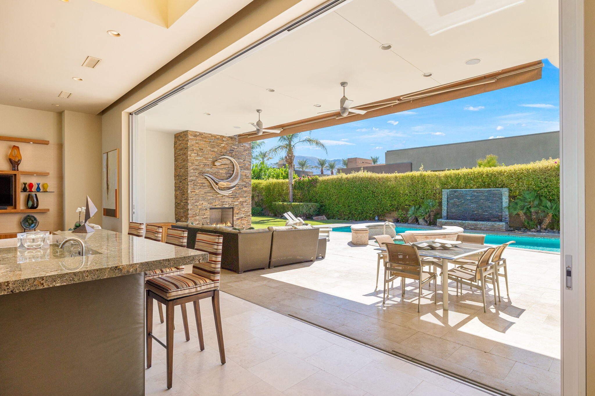28 Sun Ridge Circle Rancho Mirage, CA 92270 - Photo 12 of 59 a living room with fireplace furniture and a large window