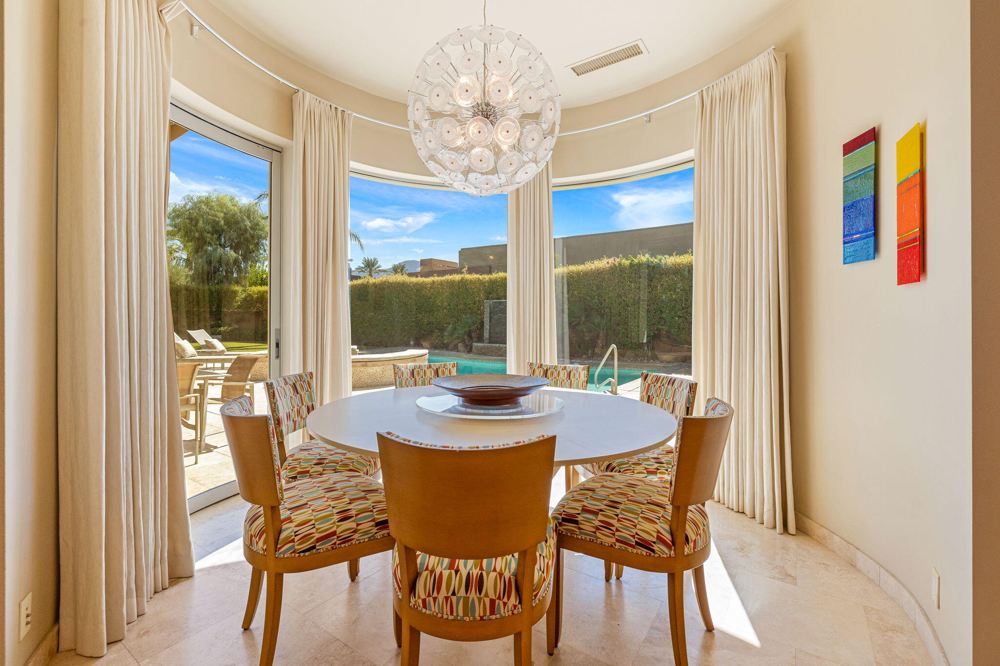 28 Sun Ridge Circle Rancho Mirage, CA 92270 - Photo 17 of 59 a view of a dining room with furniture a chandelier and large window