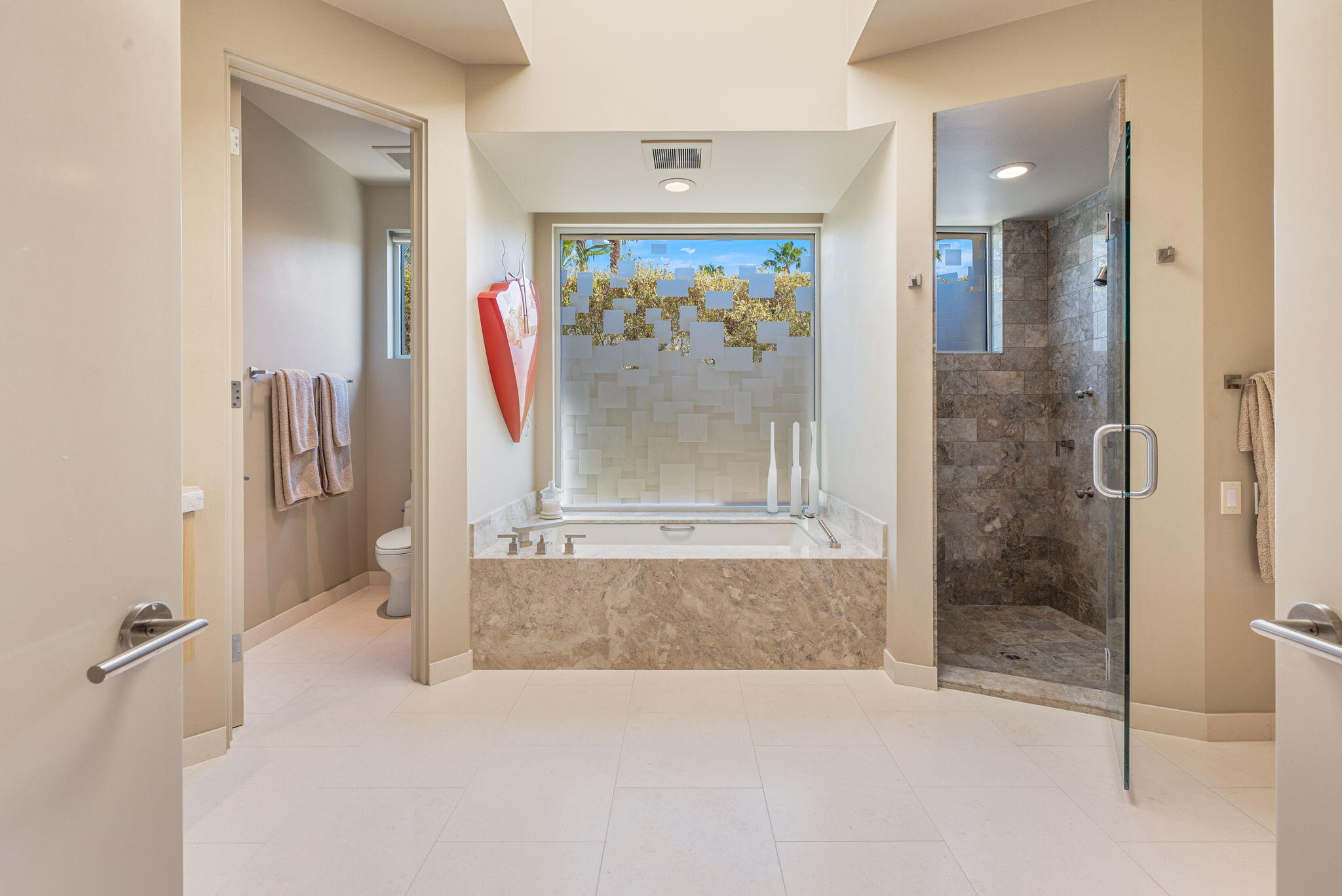28 Sun Ridge Circle Rancho Mirage, CA 92270 - Photo 30 of 59 a view of a bathroom with a glass shower door