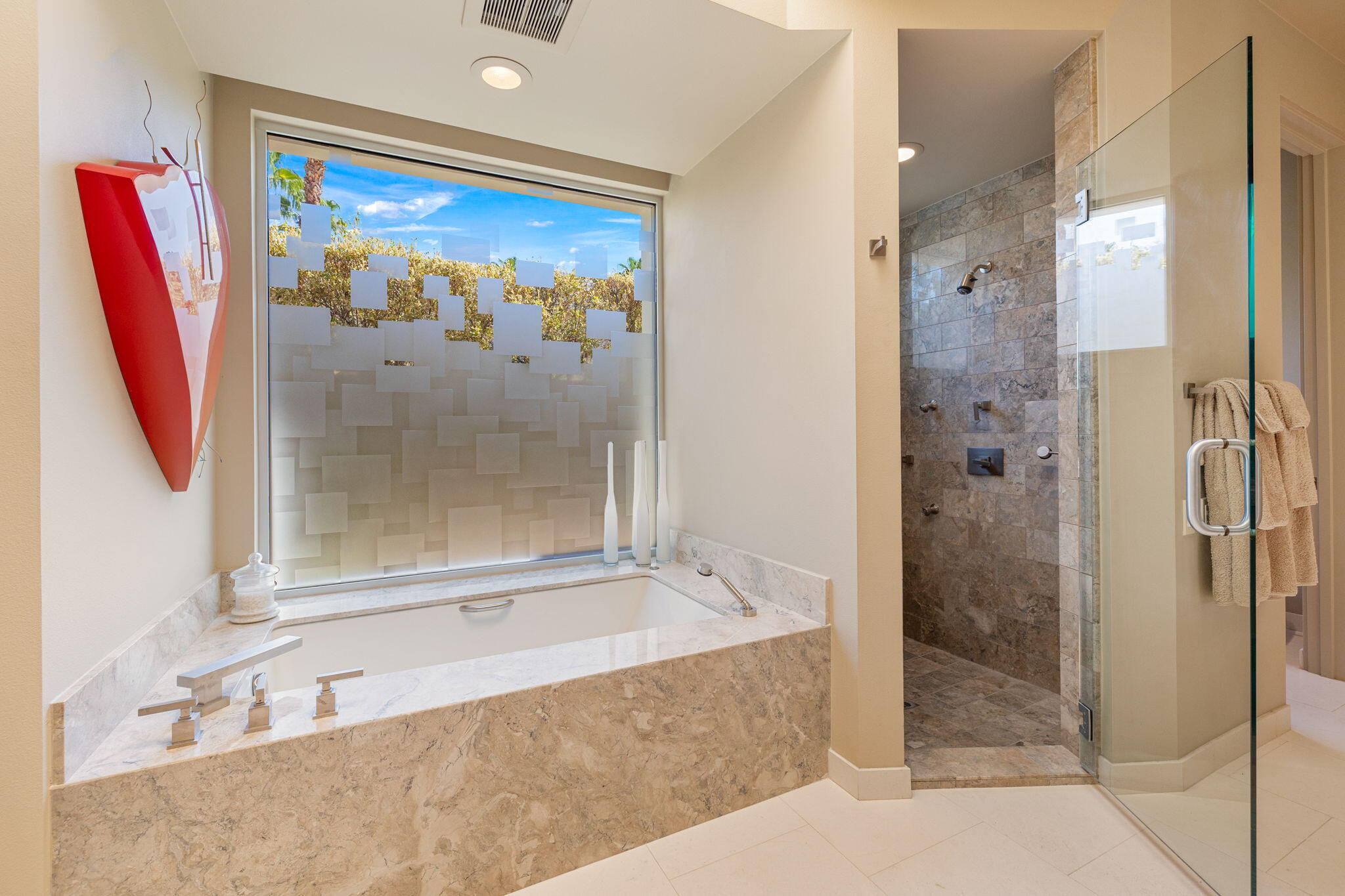 28 Sun Ridge Circle Rancho Mirage, CA 92270 - Photo 33 of 59 a bathroom with a tub and a glass door