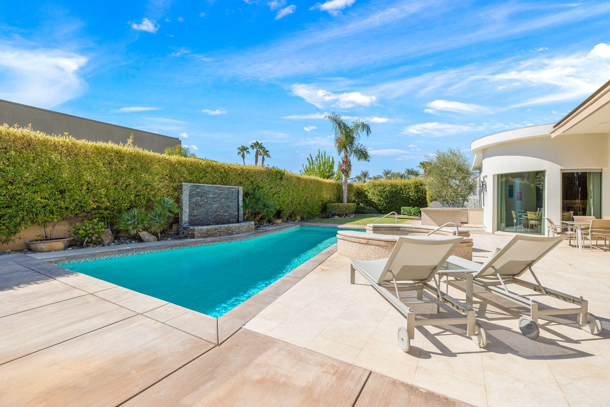 28 Sun Ridge Circle Rancho Mirage, CA 92270 - Photo 50 of 59 a view of a patio with dining table and chairs with a fire pit