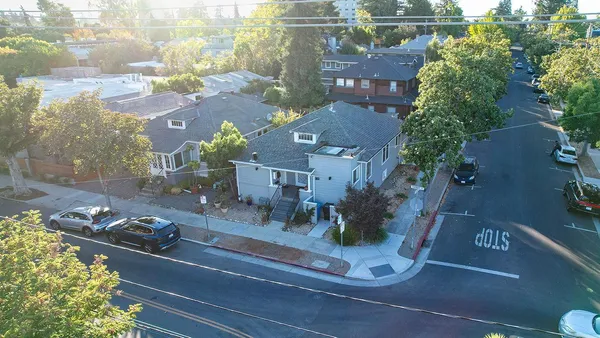 an aerial view of a house with garden space and street view