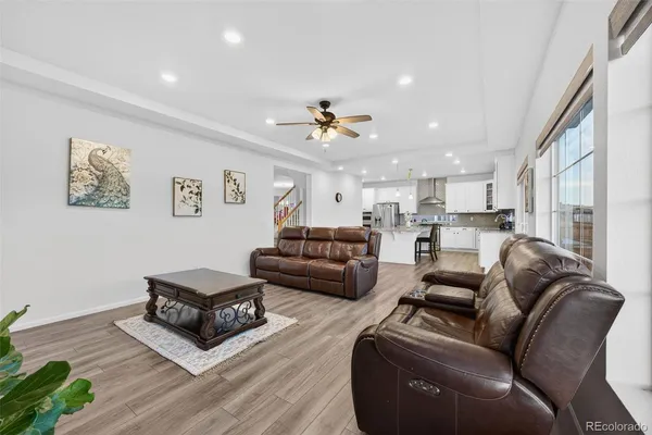 a living room with furniture ceiling fan and a rug