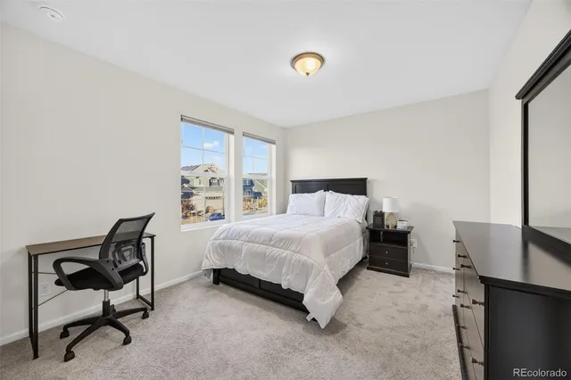 a bedroom with a bed chair and window