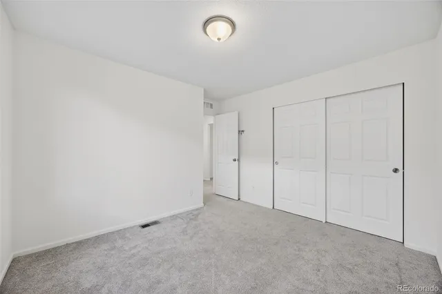 a view of an empty room and a window