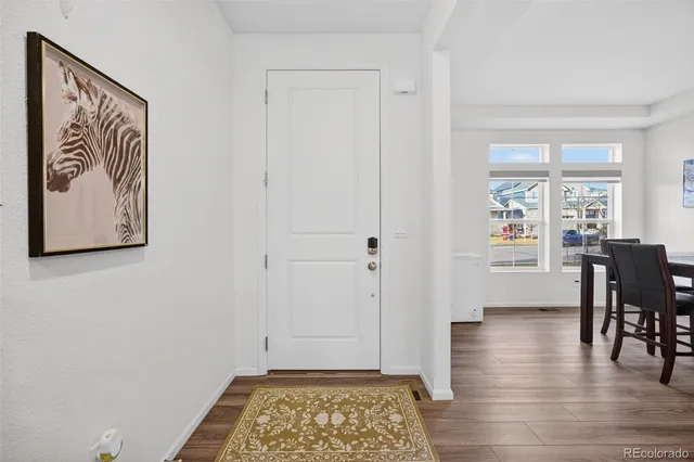 a view of a hallway with furniture and wooden floor