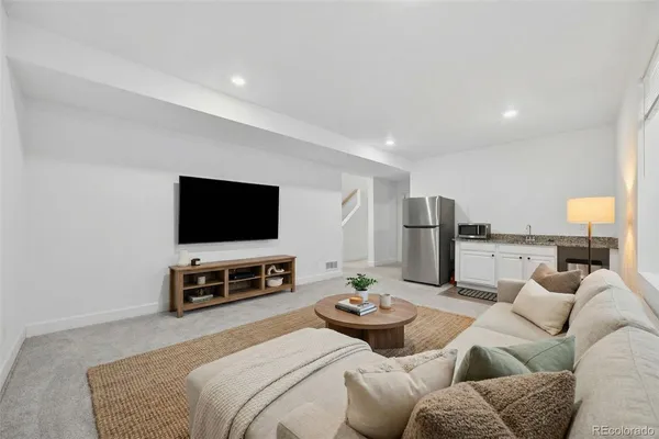 a bathroom with a granite countertop sink a toilet and shower