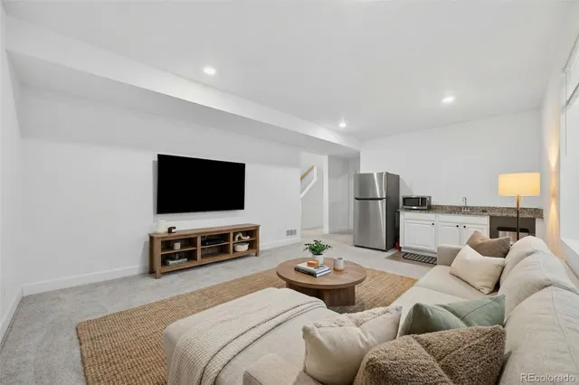 a bathroom with a granite countertop sink a toilet and shower
