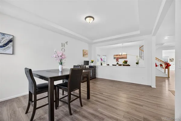 a view of a dining room with furniture and wooden floor