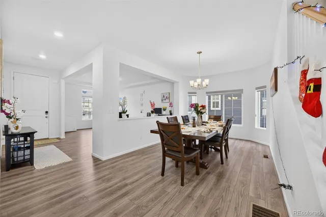 a view of a dining room with furniture and wooden floor