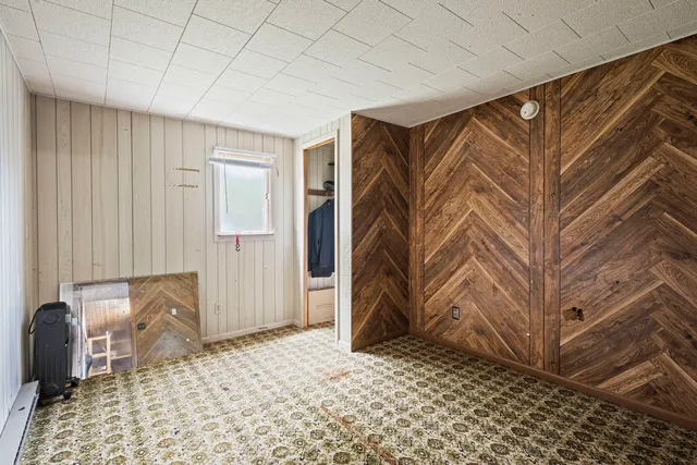 a bedroom with a bed and a chair