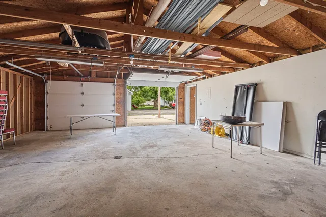 a view of a room with table and chairs