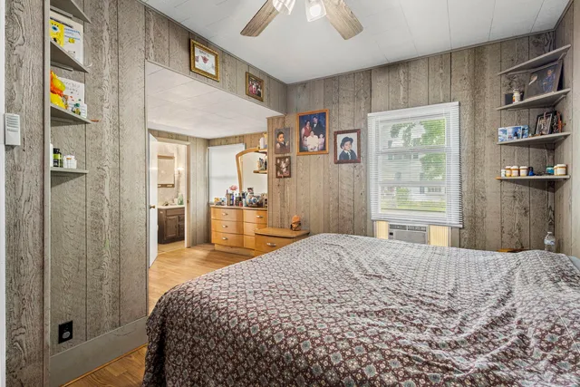 a bedroom with a bed and a chandelier