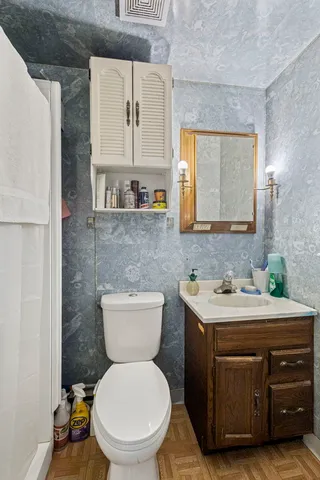 a bathroom with a toilet sink and mirror