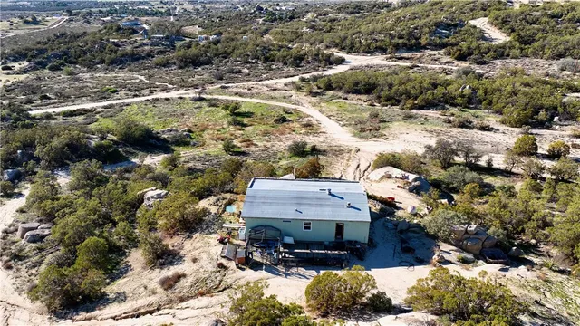 an aerial view of a house and a mountain view