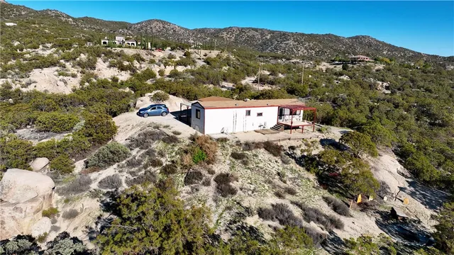 an aerial view of a house with a mountain view
