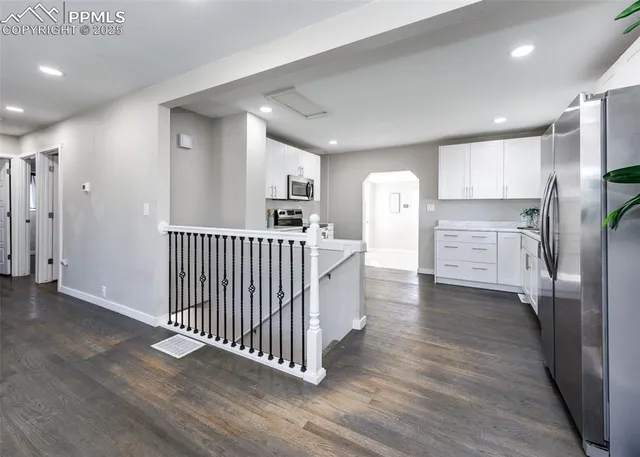 a view of a kitchen with a sink and stainless steel appliances