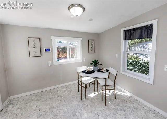 a dining room with a window and furniture