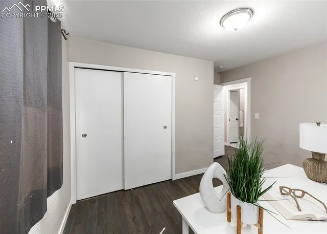 a view of a room with wooden floor and bathroom