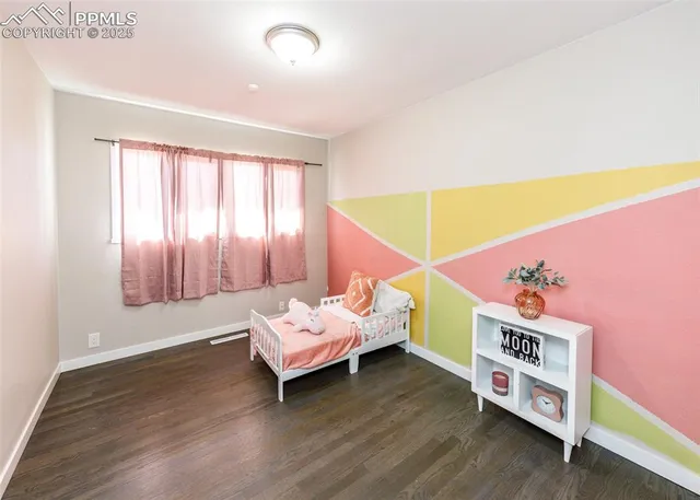 a bedroom with furniture and a wooden floor