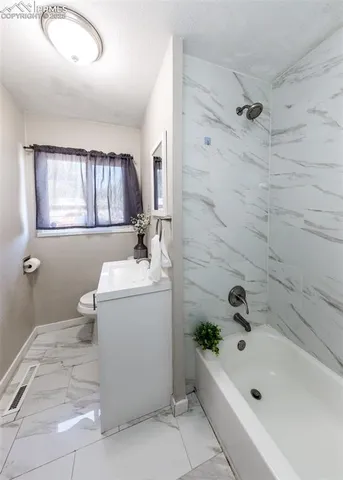 a bathroom with a sink a bathtub and shower