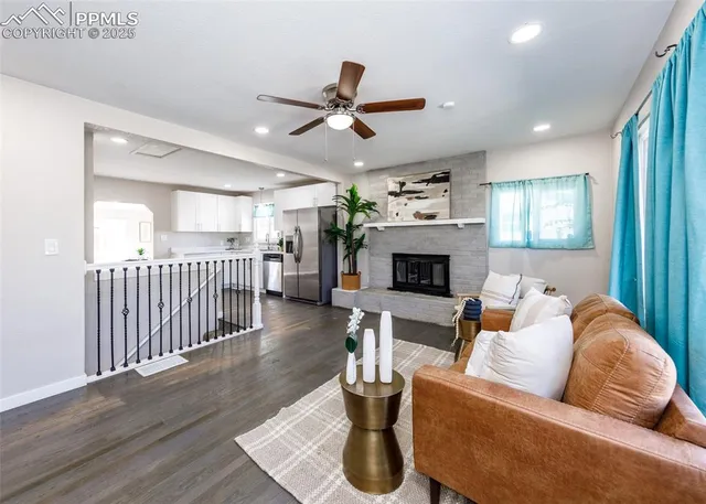 a living room with furniture and a fireplace