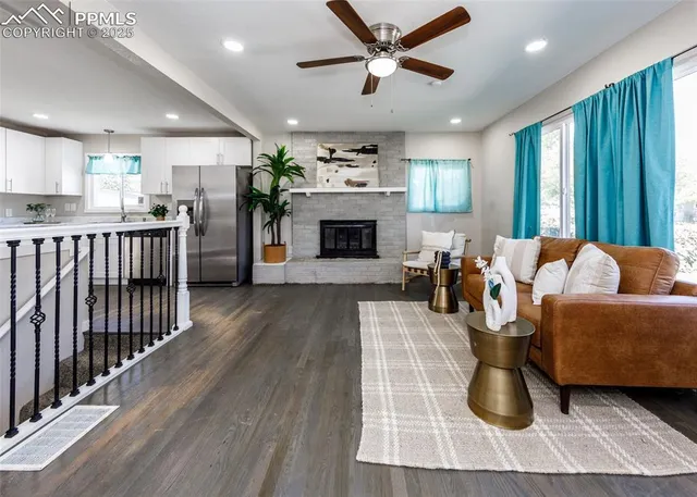 a living room with furniture a fireplace and a chandelier