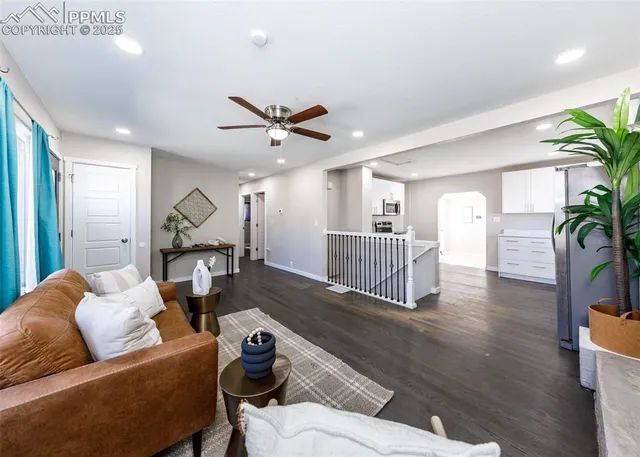 a living room with furniture and a wooden floor