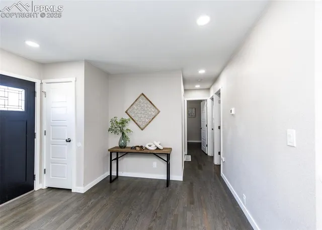 a view of a hallway and wooden floor