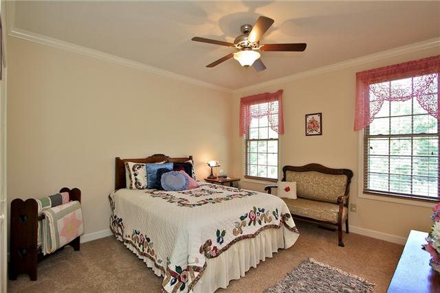 1214 Ben Collier Road Charlotte, TN 37036 - Photo 13 of 20 a bedroom with a bed a couch and a large window