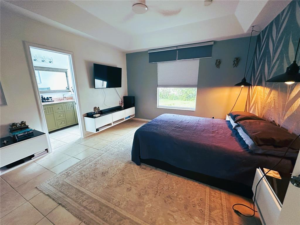 700 Castillo Place St. Cloud, FL 34769 - Photo 13 of 43 a bedroom with a bed and flat screen tv