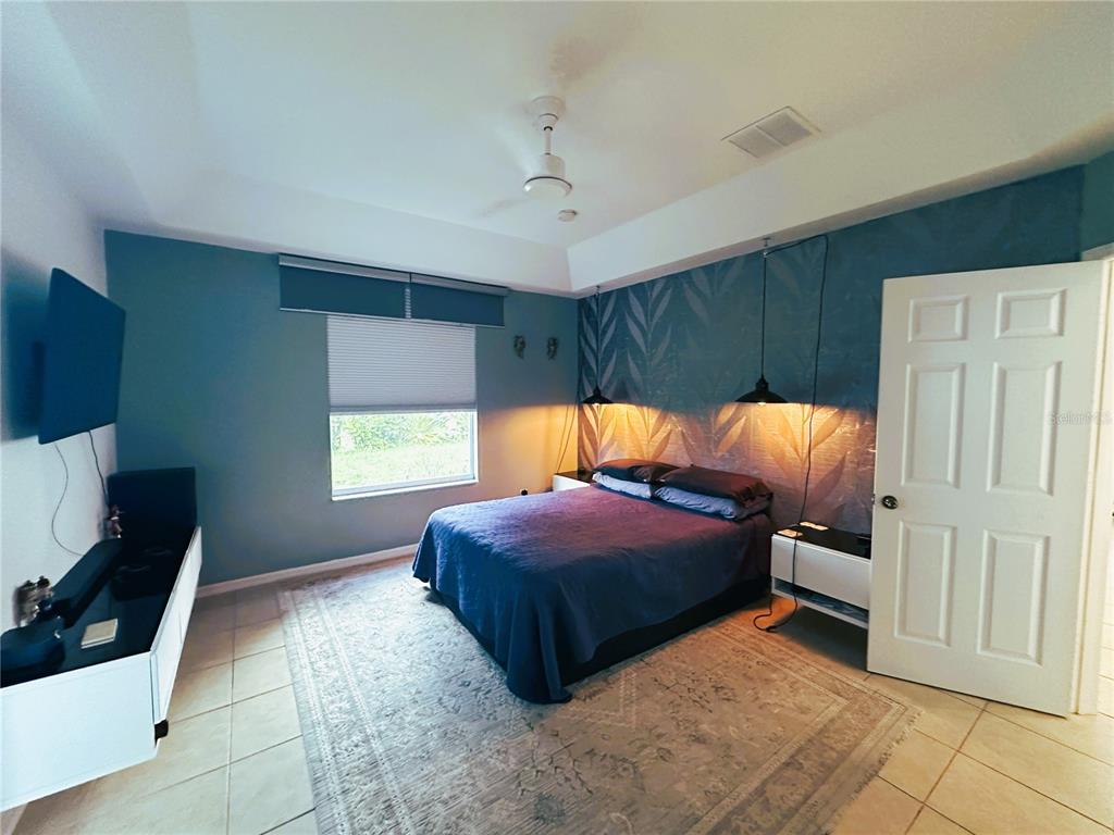700 Castillo Place St. Cloud, FL 34769 - Photo 14 of 43 a bed room with a bed and a window