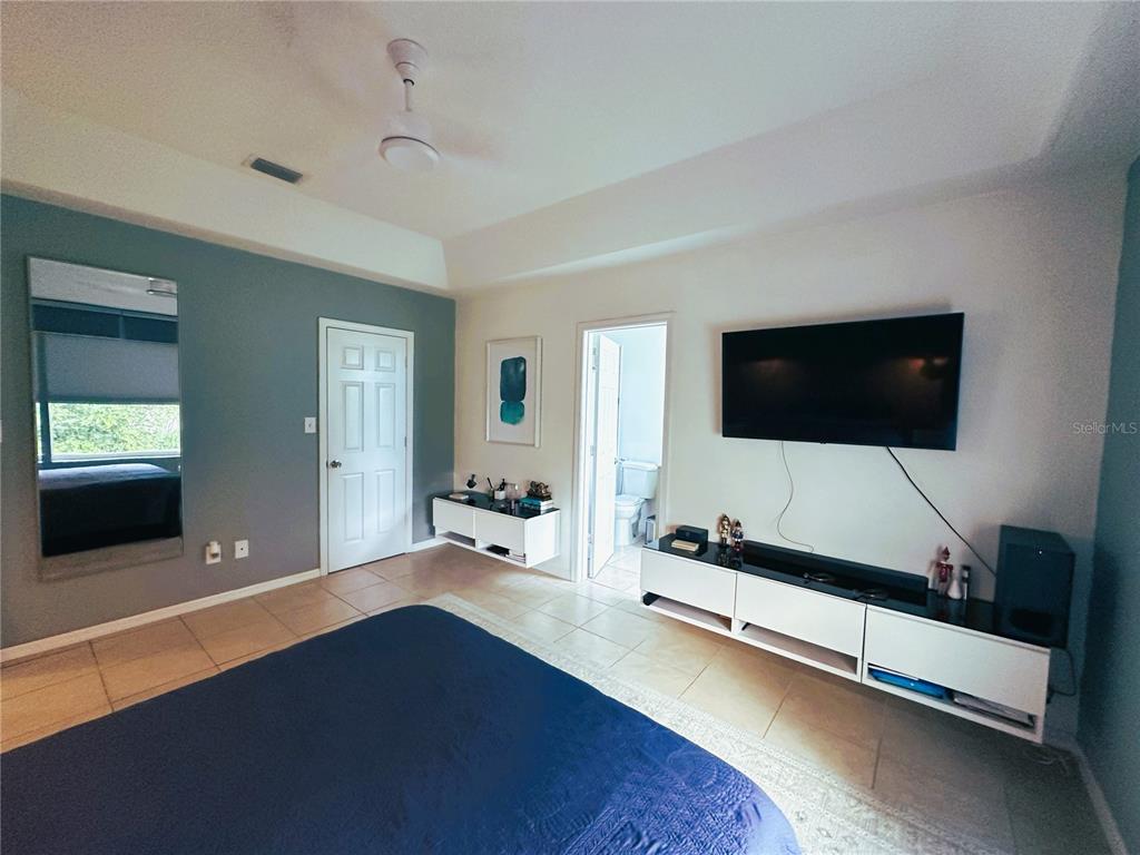 700 Castillo Place St. Cloud, FL 34769 - Photo 15 of 43 a bedroom with bed and flat screen tv