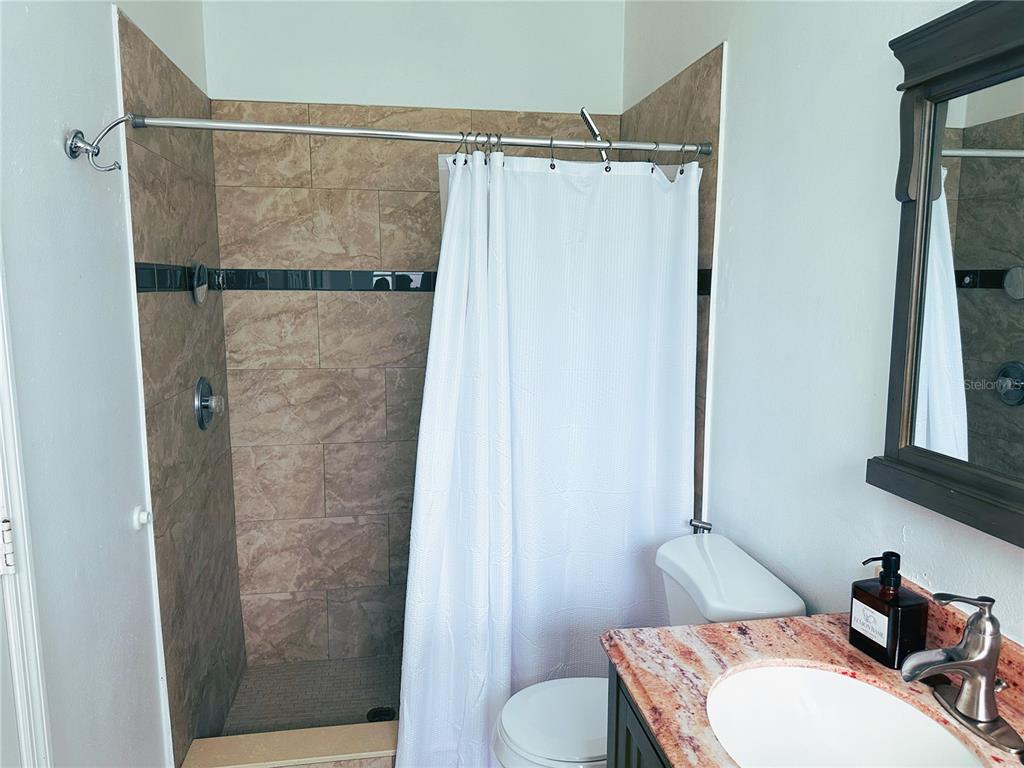 700 Castillo Place St. Cloud, FL 34769 - Photo 18 of 43 a bathroom with a sink and a mirror