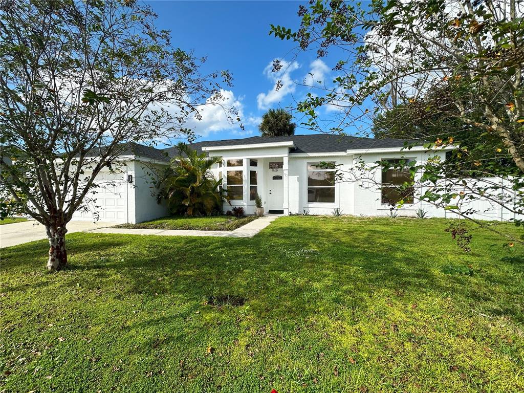700 Castillo Place St. Cloud, FL 34769 - Photo 2 of 43 front view of house with a yard